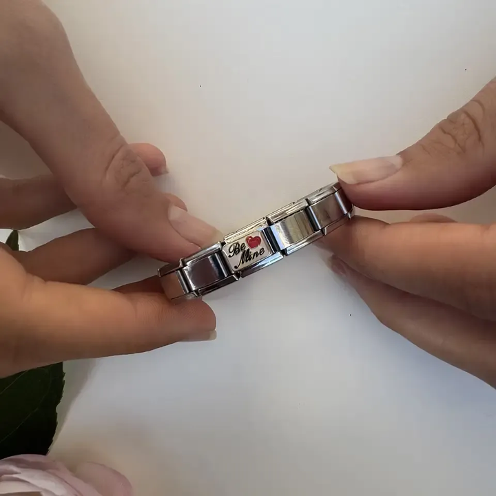 "Be Mine" text with a red heart design on a gold-plated Italian charm bracelet link