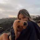 Girl hugging brown puppy
